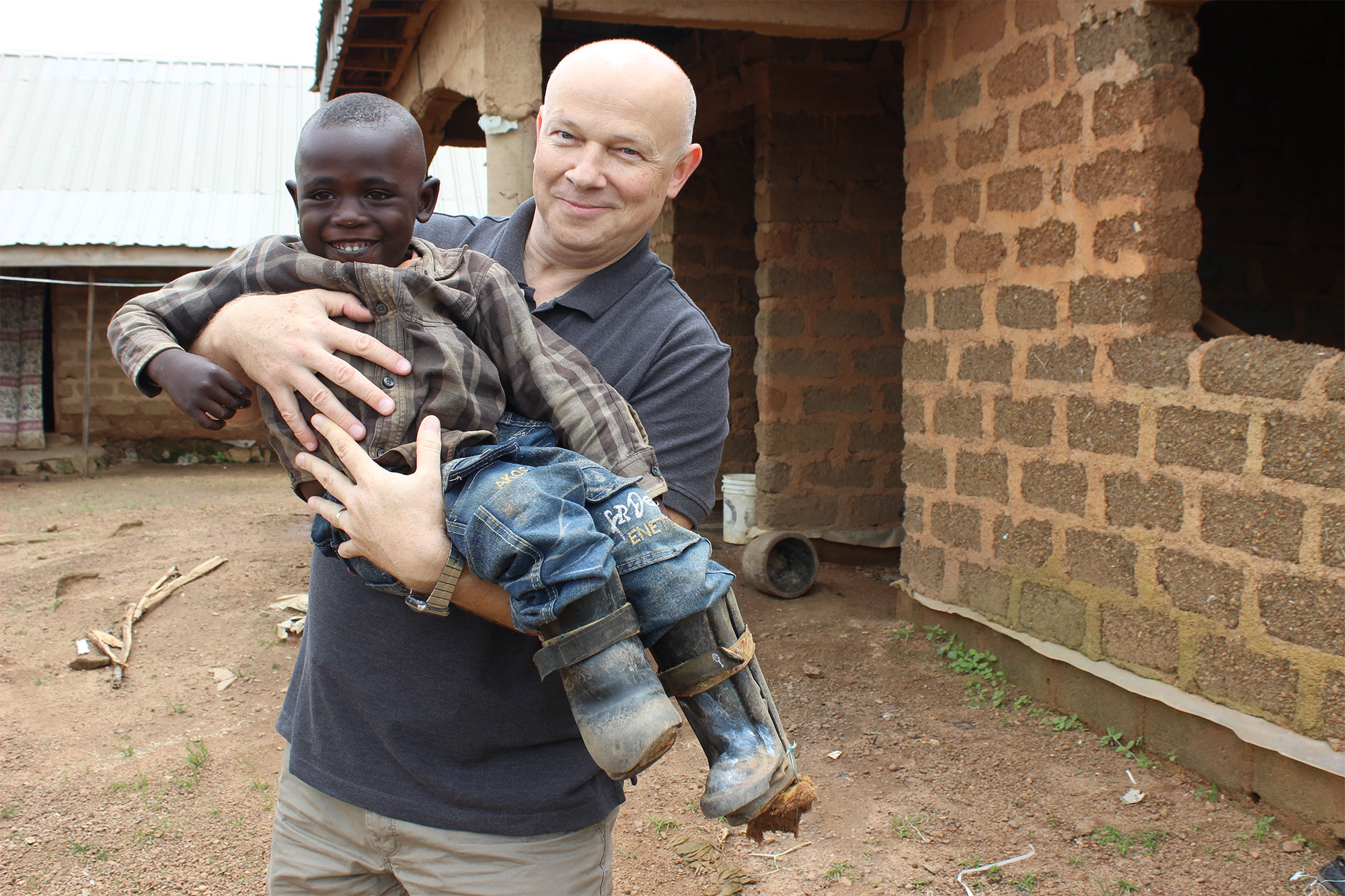 Petr holding up smiling young boy